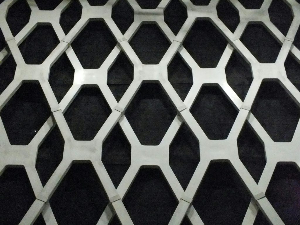 a black and white photo of a metal grate